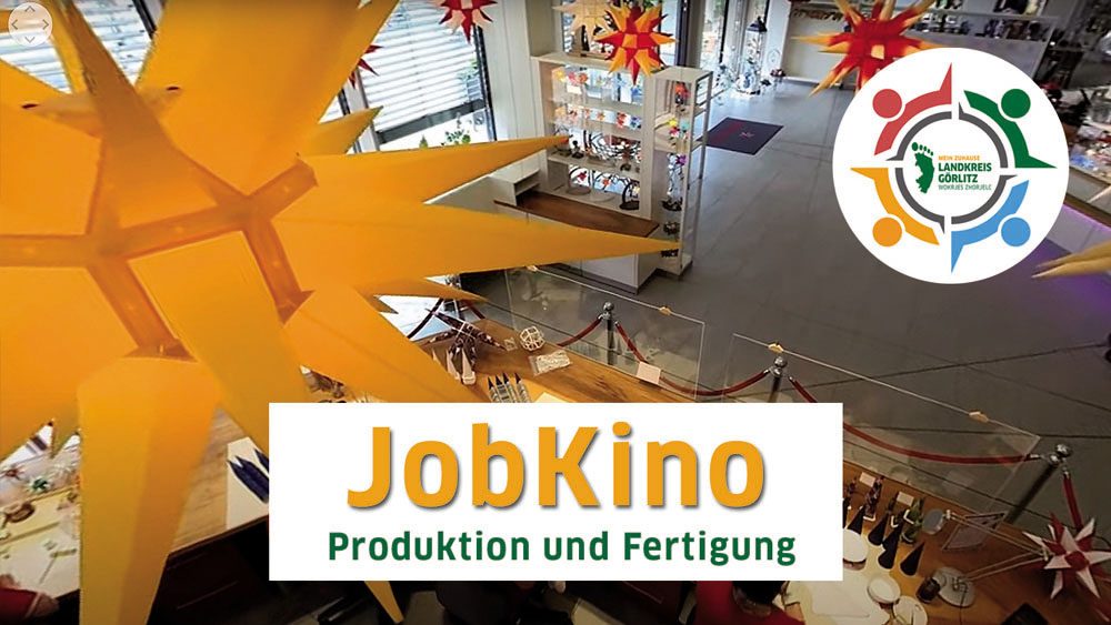Innenansicht eines Veranstaltungsorts mit Sternen und dem Schriftzug "JobKino Produktion und Fertigung".